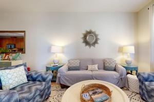 a living room with a couch and a table at Hill Country Corner Condo at The Waters - Central AC, Lake Views & Pool in Horseshoe Bay