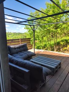 a patio with couches on a wooden deck at Imprezowy domek in Żeleźnikowa Wielka