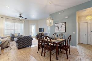 a living room with a table and chairs and a couch at Hill Country Corner Condo at The Waters - Central AC, Lake Views & Pool in Horseshoe Bay