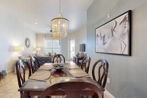 a dining room with a table with chairs and a couch at Hill Country Corner Condo at The Waters - Central AC, Lake Views & Pool in Horseshoe Bay +18 photos