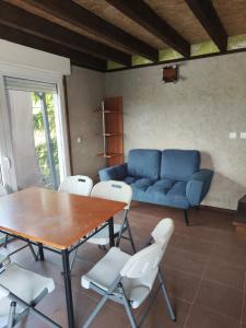 a living room with a table and a blue couch at Imprezowy domek in Żeleźnikowa Wielka