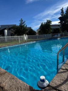 a blue swimming pool with a white fence at Hostal Almendral in San Felipe