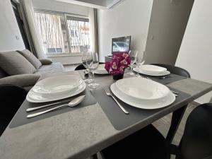 a dining room table with plates and wine glasses at Makala Accommodation in Split