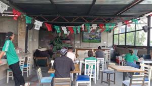 a group of people sitting at tables in a restaurant at Nomaddicts in Mexico City