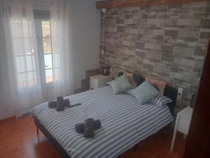 a bedroom with a bed with two hats on it at Volcán de la Corona House in Punta Mujeres