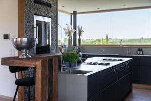 a kitchen with a stove top oven next to a window at Eifelvilla Weber in Arenrath