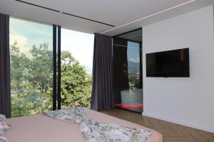 a bedroom with a bed and a large window at Panorama Hill Villa Tirana - Private Pool & Views in Tirana
