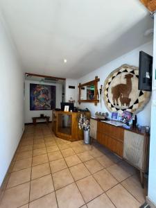 a living room with a tiled floor and a tv at Hostal Almendral in San Felipe