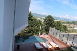 a swimming pool with a pink flamingo on a balcony at Panorama Hill Villa Tirana - Private Pool & Views in Tirana
