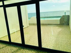 a room with a view of the ocean through a window at Casa del Mar Residences in Kelibia