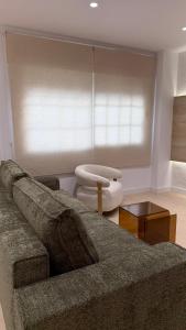 a living room with a couch and a window at Palacios Centro - El Puerto in El Puerto de Santa María