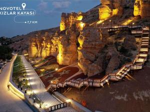 a view of a mountain at night with lights at Ibis Konya in Konya