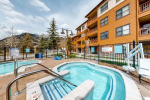 a swimming pool in front of a building at Copper Springs Lodge 101 in Copper Mountain