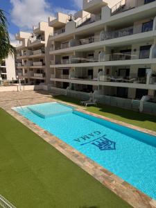 an empty swimming pool in front of a building at Casa Emilia in San Javier