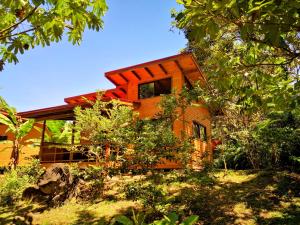 a house on top of a hill with trees at Thoas Lodge in Coronado