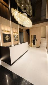 a large room with a white table and a staircase at Ameli Plaza Hotel Tashkent in Yakkasaray
