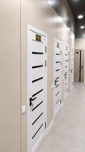 a row of white lockers in a hallway at Ameli Plaza Hotel Tashkent in Yakkasaray