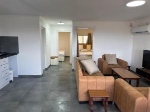 a living room with two couches and a television at carmel cabins suite nu 9 in Yājur