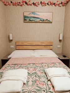 a bedroom with a bed with two pillows on it at BED & BREAKFAST SAKURA in Milan