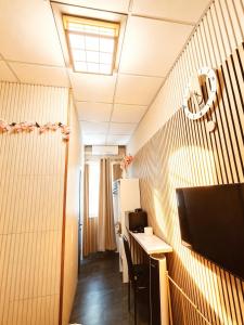 a small room with a desk and a television at BED & BREAKFAST SAKURA in Milan +21 photos
