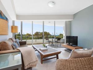 a living room with a couch and a tv at The Sebel Maroochydore in Maroochydore +73 photos