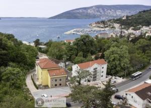 a view of a town with a lake and a city at Shark Herceg Novi in Meljine