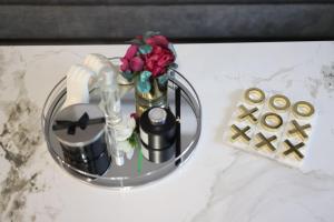 a table with a vase with flowers and a sink at Pasture Side House in Clayton