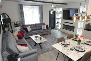 a living room with a couch and a table at Pasture Side House in Clayton