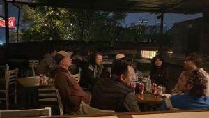 a group of people sitting at tables in a restaurant at Nomaddicts in Mexico City