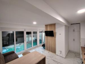 a living room with a couch and a tv in it at Shark Herceg Novi in Meljine
