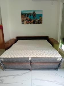 a bed sitting in a room with at Shark Herceg Novi in Meljine
