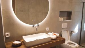 a bathroom with a sink and a toilet and a mirror at Villa Tarrafal in Somone +27 photos
