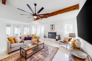 a living room with a couch and a ceiling fan at Peaceful Mid-Century Escape with Screened Porch & Lake Access in Lago Vista