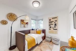 a bedroom with a bed and a lamp in it at Peaceful Mid-Century Escape with Screened Porch & Lake Access in Lago Vista