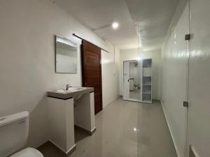 a bathroom with a sink and a toilet and a mirror at Jimbaran Hostel Bali in Jimbaran +23 photos