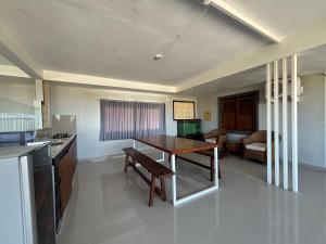 a kitchen with a table and a dining room at Jimbaran Hostel Bali in Jimbaran
