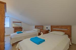 a bedroom with three beds with blue towels on them at Villa Ahad in Fethiye +35 photos
