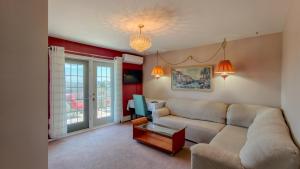 a living room with a couch and a table at Lee's Ocean Peek B & B in Stratford