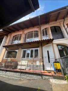 a house with a porch and a white door at Cà Dal Vindu in Biella +10 photos