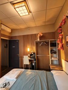 a bedroom with a bed and a desk in a room at BED & BREAKFAST SAKURA in Milan