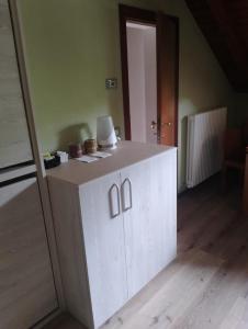 a white cabinet in the middle of a room at Casa All'Angelo in Piovene Rocchette