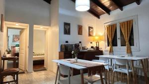 a room with two tables and chairs and a bedroom at Cuatro Soles in Ezeiza +14 photos