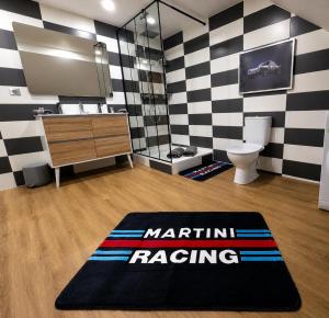 a bathroom with a black and white checkered wall at Suite Le Mans 70 in Pusey