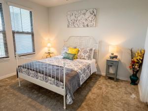 a bedroom with a white bed and two windows at Coastal Life at Aqua in Bradenton +12 photos
