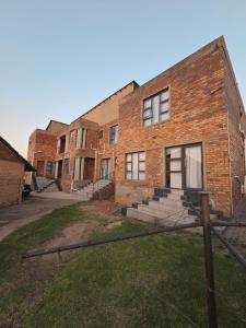 an old brick building with steps in front of it at Mafjoint10 in eMalahleni
