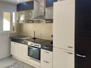a kitchen with a sink and a stove at La Perle de Bizerte in Banzart