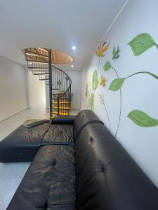 a room with a couch and a wall with a mural at La Perle de Bizerte in Banzart