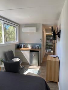 a room with a bed and two chairs and a kitchen at The Barn Top Noojee in Noojee +12 photos