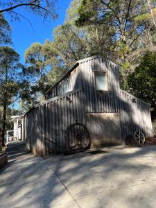 a metal building with a bike parked in it at The Barn Top Noojee in Noojee