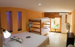 a bedroom with two bunk beds and a fan at Casa D'mer Taganga in Taganga +32 photos